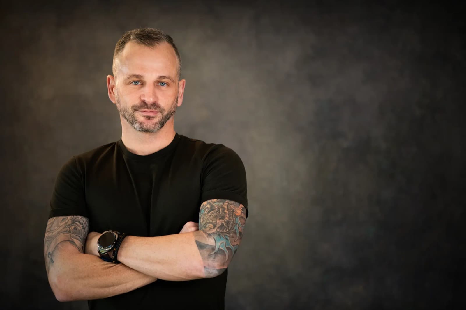 Paul Cohalan, host of The JRNY podcast, arms folded in the studio
