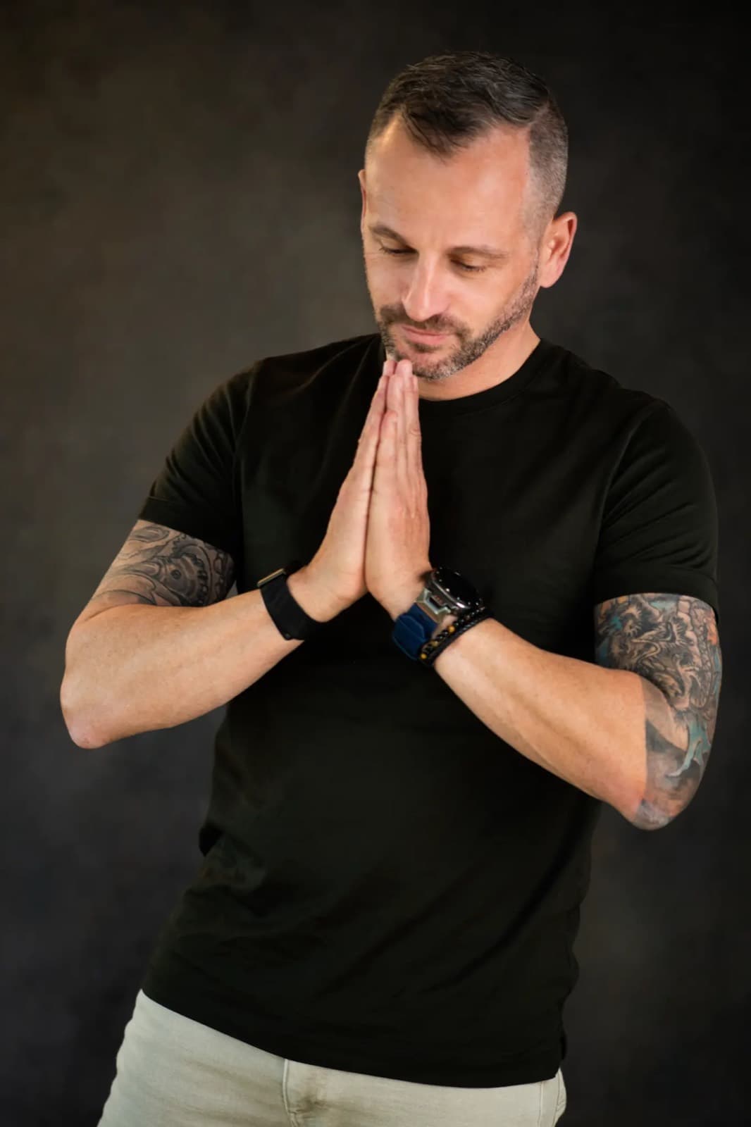 Paul Cohalan with hands pressed together, head bowed