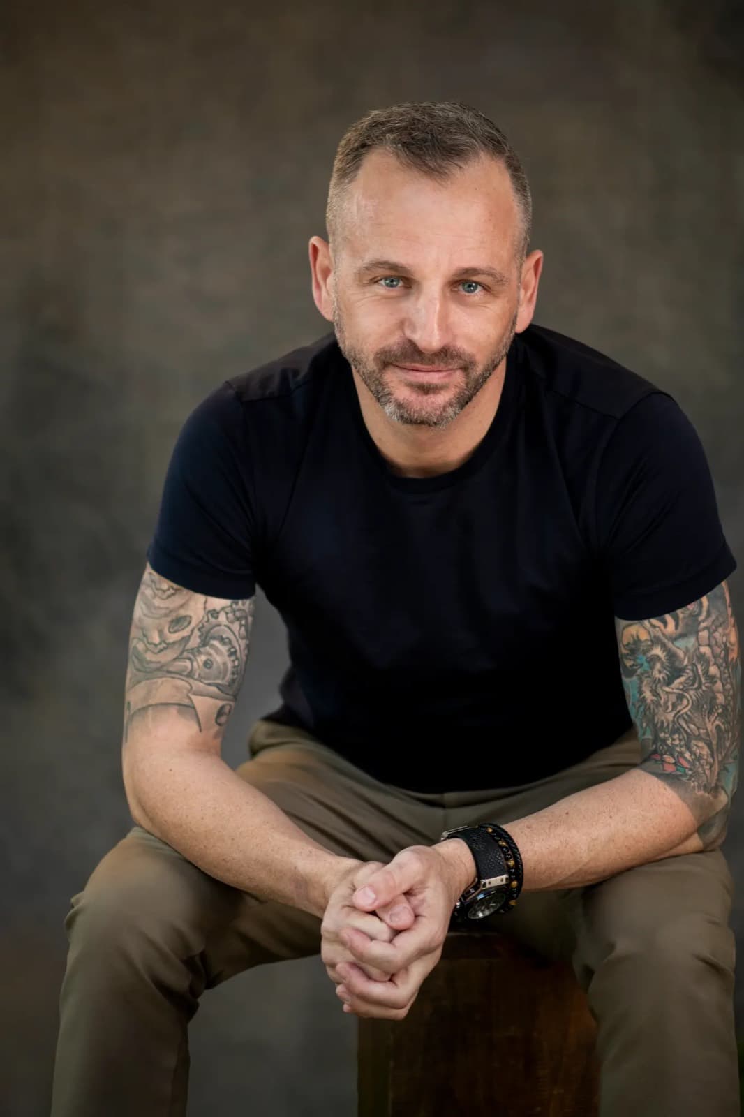 Paul Cohalan seated, hands clasped, in a black shirt